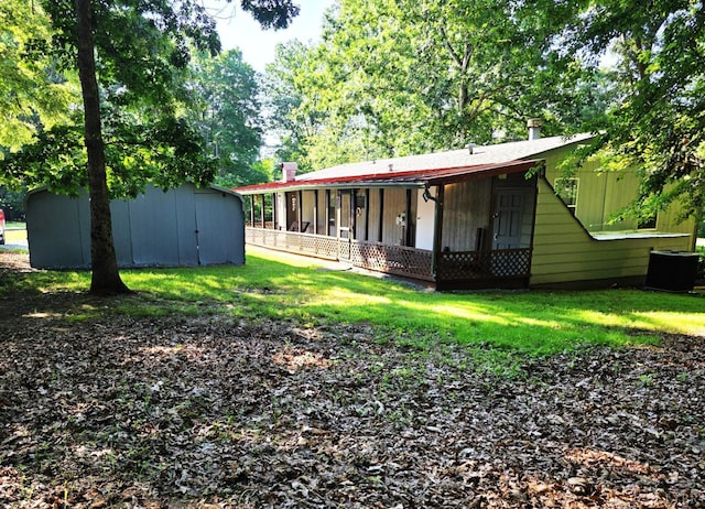 271 Candlemakers Ln, Rustburg, VA 24588 - rear view of property featuring a storage shed, a lawn, and a porch