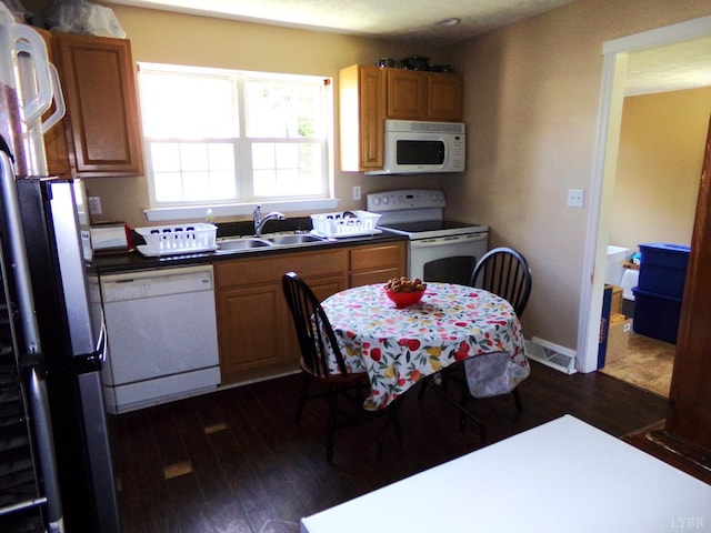 205 Tyree Cir, Madison Heights, VA 24572 - kitchen featuring white appliances, dark wood-style flooring, brown cabinetry, and dark countertops