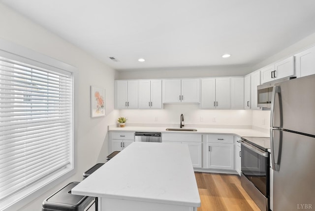 1600 Wards Fry Unit 1302, Lynchburg, VA 24502 - kitchen featuring stainless steel appliances, white cabinets, recessed lighting, light wood-style floors, and a center island