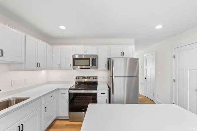 1600 Wards Fry Unit 1302, Lynchburg, VA 24502 - kitchen featuring stainless steel appliances, recessed lighting, light countertops, white cabinetry, and light wood-style flooring