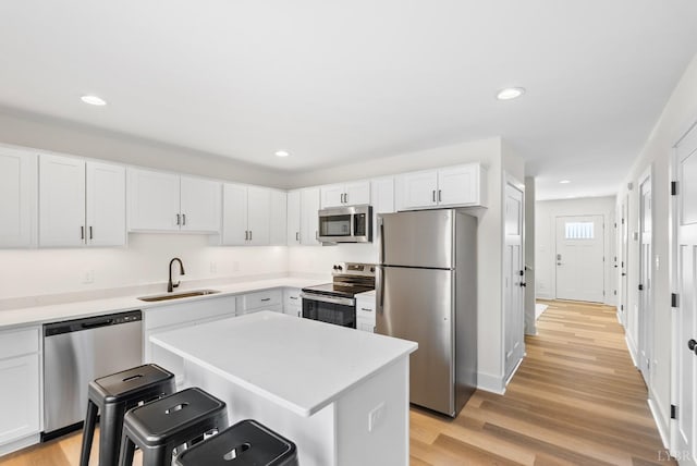 1600 Wards Fry Unit 1302, Lynchburg, VA 24502 - kitchen with stainless steel appliances, a kitchen breakfast bar, white cabinets, light wood finished floors, and recessed lighting