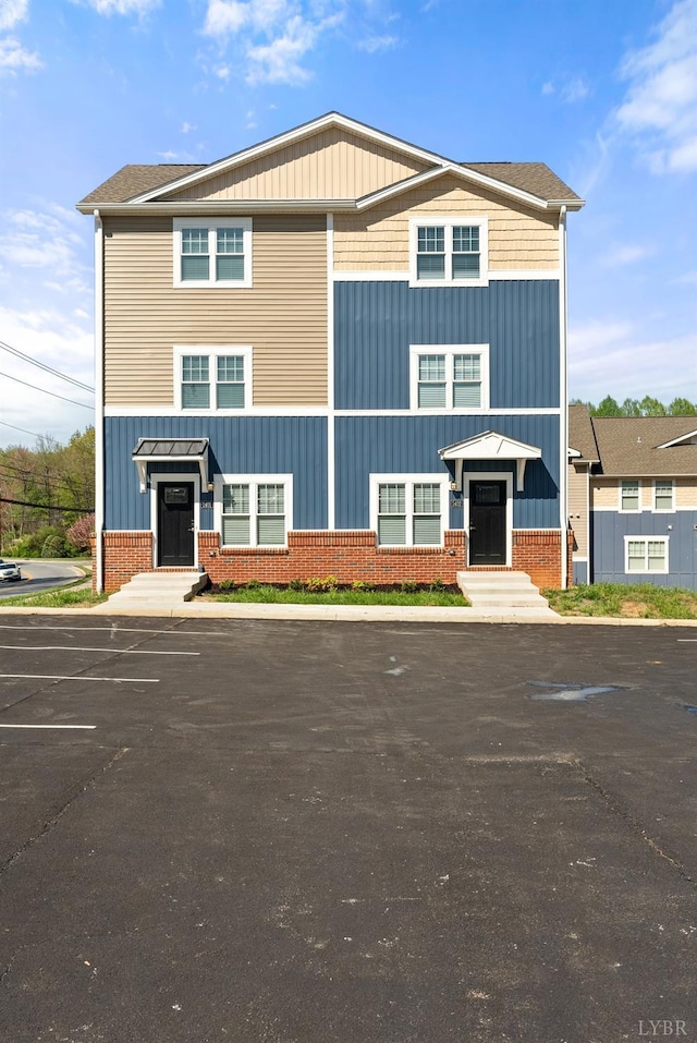 1600 Wards Fry Unit 1302, Lynchburg, VA 24502 - view of front facade featuring board and batten siding, uncovered parking, and brick siding