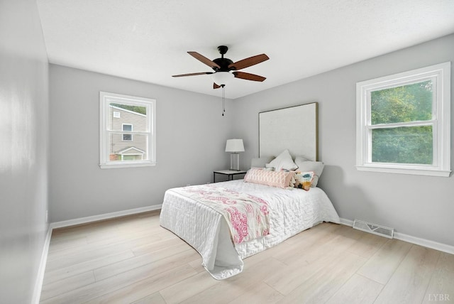 2824 Hawkins Mill Rd, Lynchburg, VA 24502 - bedroom with multiple windows, light wood-style floors, and ceiling fan