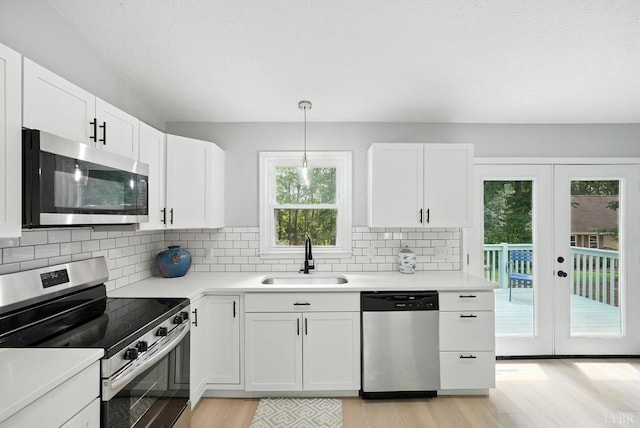 2824 Hawkins Mill Rd, Lynchburg, VA 24502 - kitchen featuring stainless steel appliances, light wood-type flooring, french doors, white cabinets, and a textured ceiling