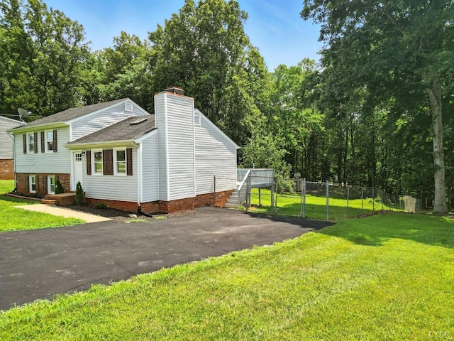 2824 Hawkins Mill Rd, Lynchburg, VA 24502 - view of property exterior featuring a chimney, asphalt driveway, and roof with shingles