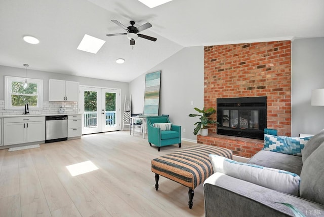 2824 Hawkins Mill Rd, Lynchburg, VA 24502 - living room featuring a skylight, a ceiling fan, light wood-type flooring, healthy amount of natural light, and vaulted ceiling