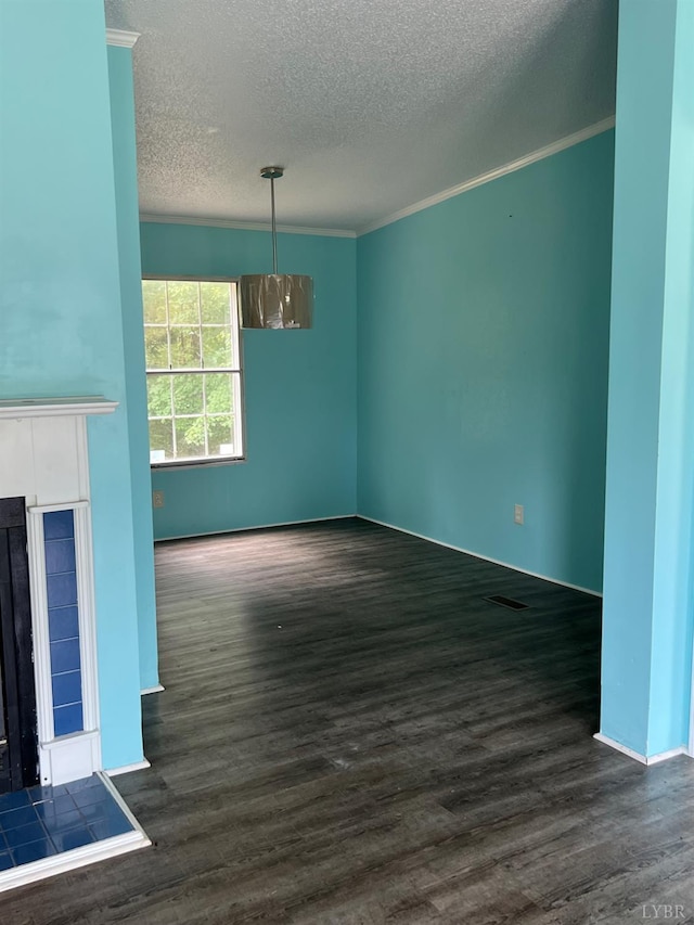 12440 E Gretna Rd, Gretna, VA 24557 - unfurnished living room with a textured ceiling, dark wood-style floors, a tiled fireplace, and crown molding