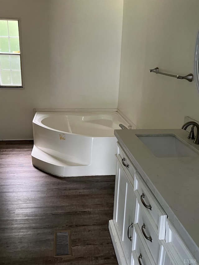 12440 E Gretna Rd, Gretna, VA 24557 - full bathroom featuring vanity, a garden tub, and wood finished floors