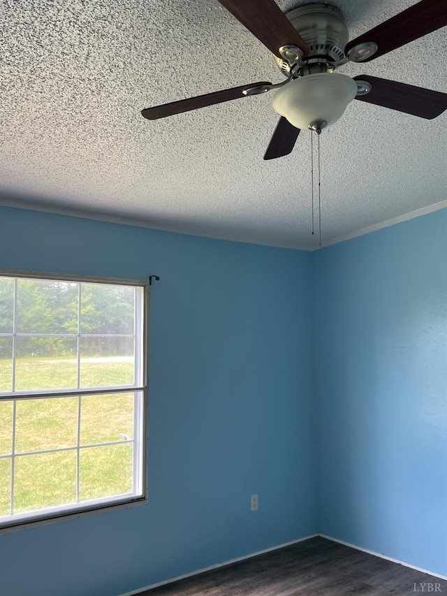 12440 E Gretna Rd, Gretna, VA 24557 - unfurnished room featuring a textured ceiling, a ceiling fan, and dark wood finished floors