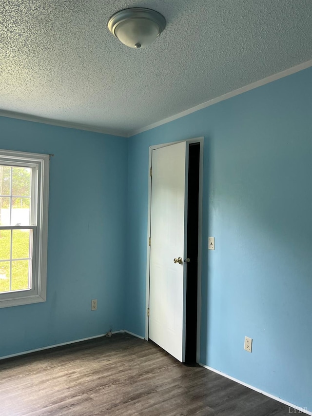 12440 E Gretna Rd, Gretna, VA 24557 - empty room featuring dark wood finished floors, a textured ceiling, and ornamental molding