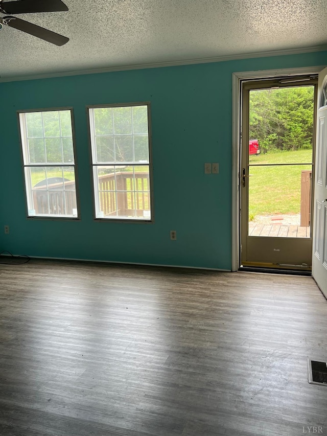 12440 E Gretna Rd, Gretna, VA 24557 - unfurnished room featuring a textured ceiling, wood finished floors, ceiling fan, and ornamental molding
