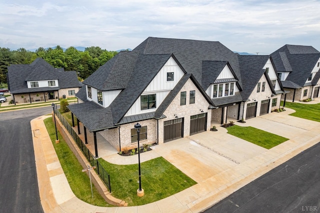 87 S Westyn Loop, Forest, VA 24551 - view of front of house with a garage, board and batten siding, concrete driveway, a shingled roof, and a standing seam roof