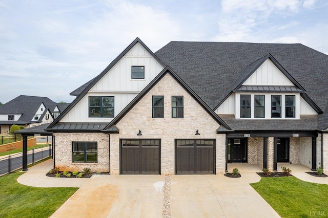 87 S Westyn Loop, Forest, VA 24551 - view of front facade with board and batten siding, a standing seam roof, an attached garage, and driveway