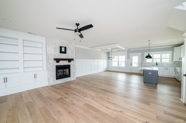 87 S Westyn Loop, Forest, VA 24551 - unfurnished living room featuring a ceiling fan, light wood-type flooring, a fireplace, built in features, and a chandelier