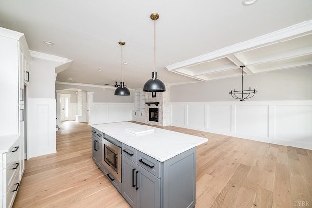 87 S Westyn Loop, Forest, VA 24551 - kitchen with stainless steel microwave, a decorative wall, gray cabinetry, open floor plan, and a fireplace