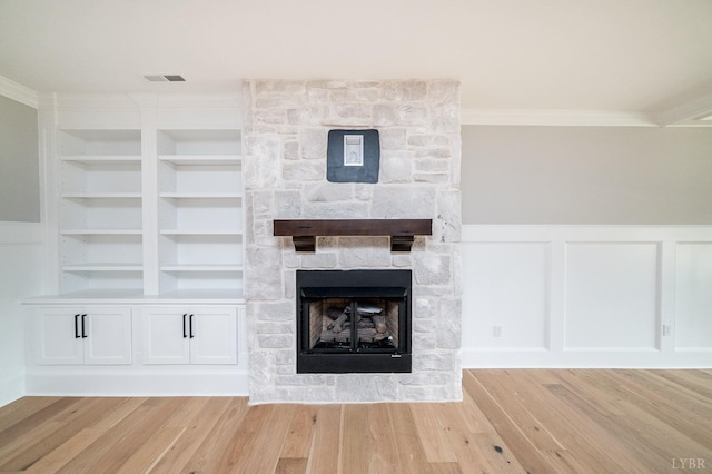 87 S Westyn Loop, Forest, VA 24551 - detailed view of a stone fireplace, crown molding, built in features, wood finished floors, and a decorative wall