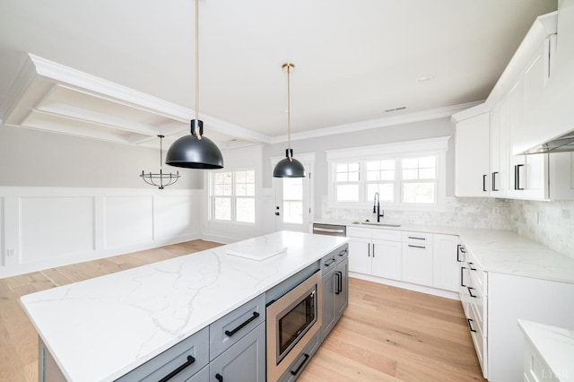 87 S Westyn Loop, Forest, VA 24551 - kitchen featuring appliances with stainless steel finishes, light wood-style flooring, ornamental molding, a kitchen island, and light stone counters