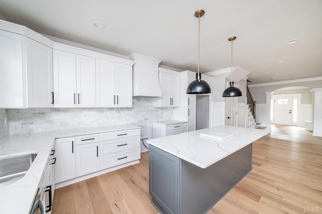 87 S Westyn Loop, Forest, VA 24551 - kitchen featuring decorative columns, arched walkways, crown molding, light stone counters, and backsplash