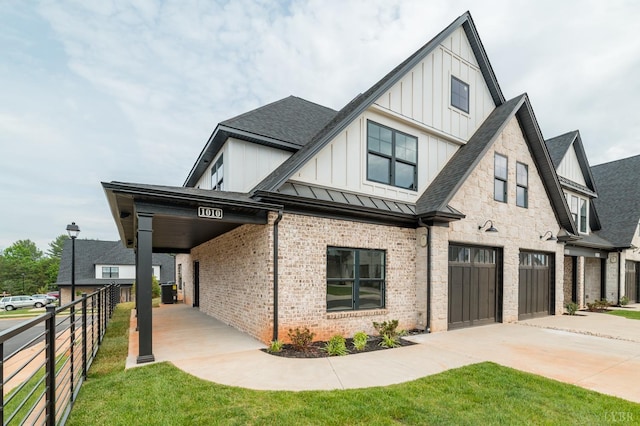 87 S Westyn Loop, Forest, VA 24551 - view of front of home with board and batten siding, driveway, a garage, brick siding, and a standing seam roof