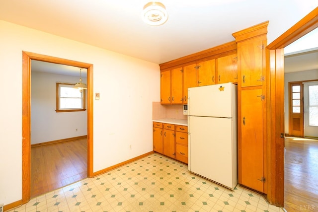 625 Sherman Dr, Lynchburg, VA 24502 - kitchen featuring freestanding refrigerator, light floors, light countertops, and brown cabinetry
