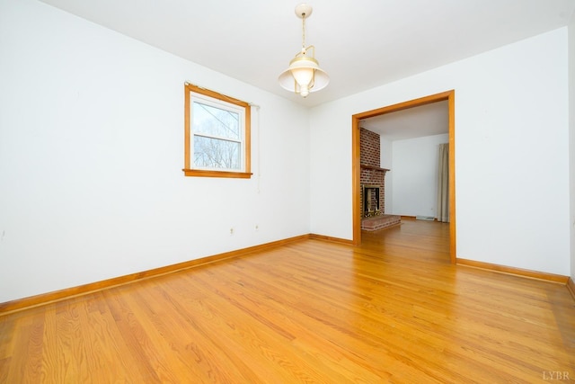 625 Sherman Dr, Lynchburg, VA 24502 - unfurnished room with light wood-style flooring and a brick fireplace