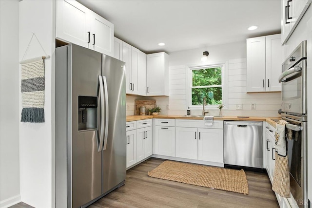 121 Brooke St, Brookneal, VA 24528 - kitchen featuring appliances with stainless steel finishes, wood counters, white cabinets, and recessed lighting