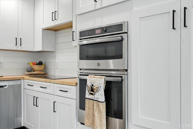 121 Brooke St, Brookneal, VA 24528 - kitchen with stainless steel appliances, wooden counters, and white cabinets