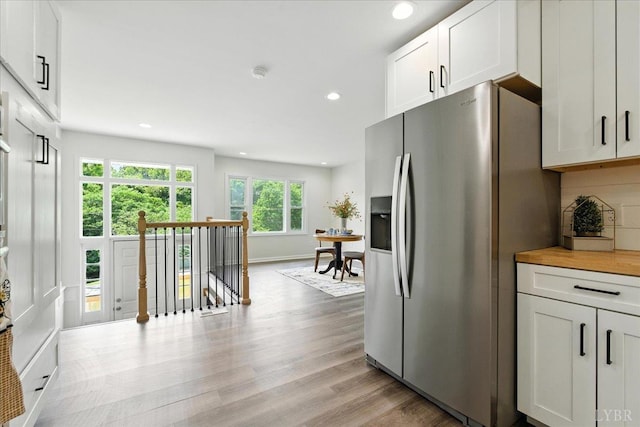 121 Brooke St, Brookneal, VA 24528 - kitchen featuring stainless steel fridge with ice dispenser, recessed lighting, white cabinets, light wood-style flooring, and decorative backsplash