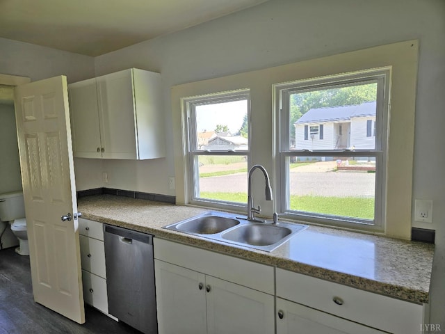 1275 Cedar Ave, Buena Vista, VA 24416 - kitchen with dishwasher, white cabinets, light countertops, and dark wood-type flooring