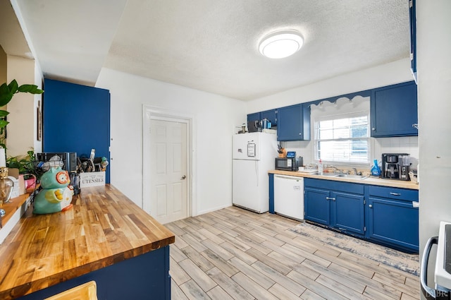 899 Brook St, Lynchburg, VA 24501 - kitchen with white appliances, blue cabinetry, wood counters, a textured ceiling, and light wood finished floors