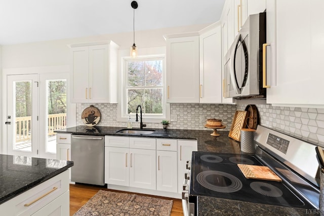 7 Hickory Cove Ln, Moneta, VA 24121 - kitchen featuring appliances with stainless steel finishes, white cabinets, tasteful backsplash, and light wood-style flooring