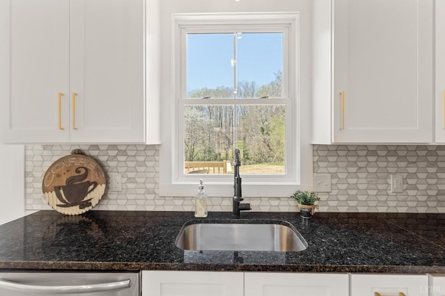 7 Hickory Cove Ln, Moneta, VA 24121 - kitchen with stainless steel dishwasher, white cabinetry, dark stone countertops, and tasteful backsplash