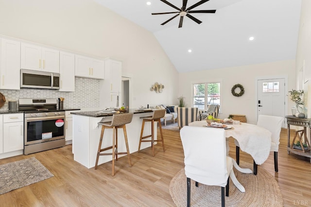 7 Hickory Cove Ln, Moneta, VA 24121 - dining space featuring high vaulted ceiling, a ceiling fan, light wood finished floors, and recessed lighting