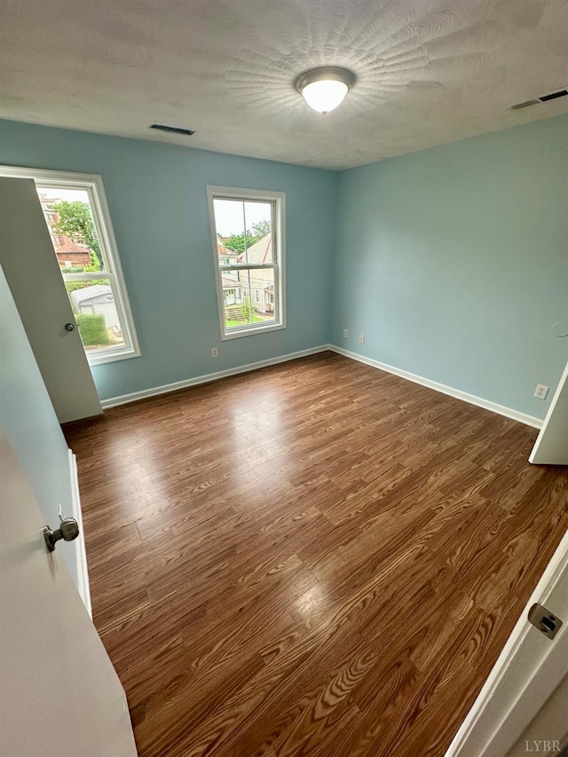 1310 9th St, Lynchburg, VA 24501 - spare room with wood finished floors and baseboards