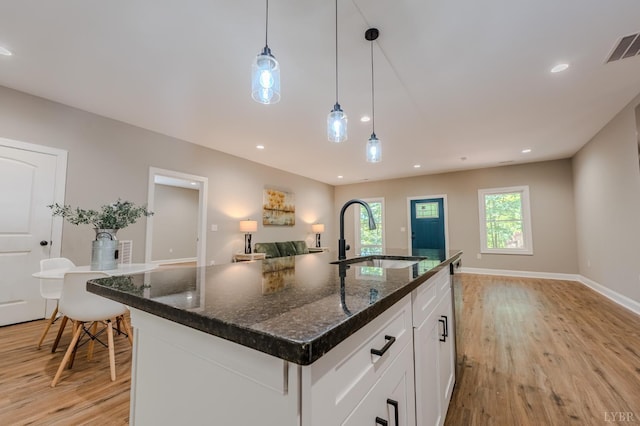 109 Tosh Ln, Goodview, VA 24095 - kitchen with light wood-style flooring, white cabinetry, hanging light fixtures, a kitchen island with sink, and recessed lighting