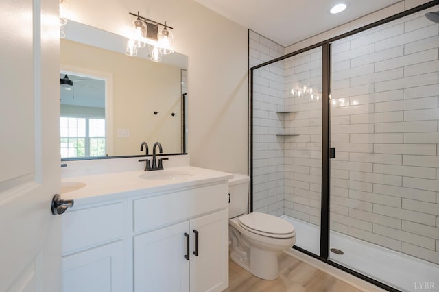 1016 Misty Mountain Rd, Lynchburg, VA 24502 - bathroom with a stall shower, double vanity, a ceiling fan, and wood finished floors