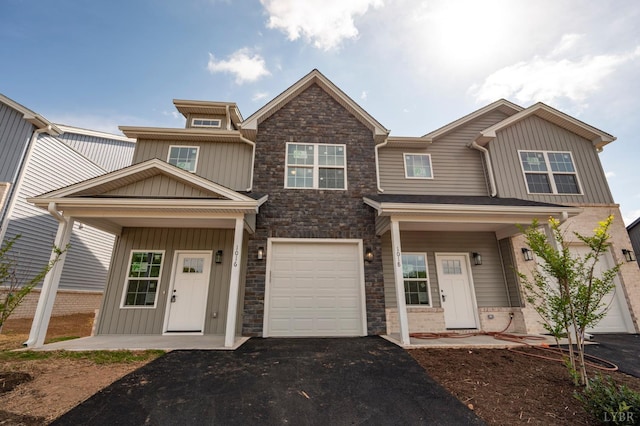 1016 Misty Mountain Rd, Lynchburg, VA 24502 - view of front facade featuring board and batten siding, asphalt driveway, covered porch, and stone siding