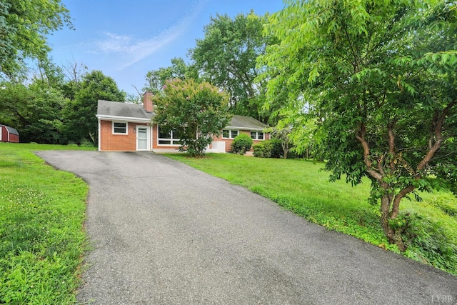 7131 Meadowbrook Rd, Lynchburg, VA 24502 - view of front facade featuring asphalt driveway, brick siding, a chimney, and a front lawn