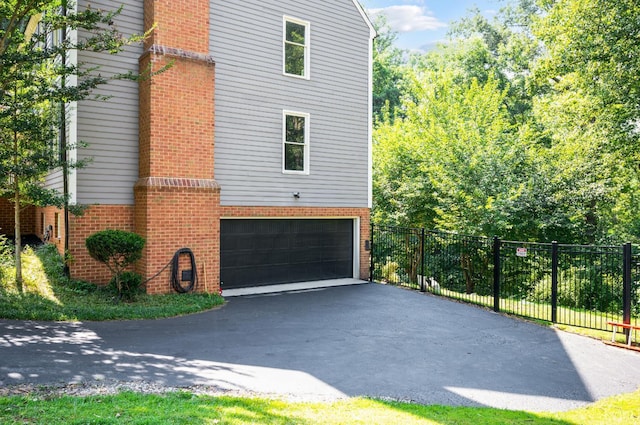 104 Overlink Ct, Lynchburg, VA 24503 - view of home's exterior with brick siding, a garage, and driveway