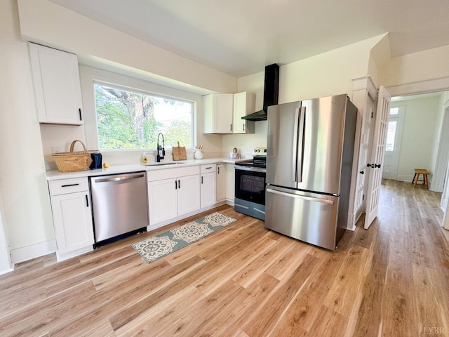 110 3rd St, Madison Heights, VA 24572 - kitchen featuring stainless steel appliances, wall chimney exhaust hood, light wood-type flooring, and white cabinets