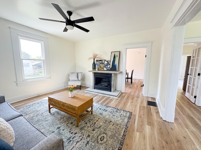 110 3rd St, Madison Heights, VA 24572 - living area featuring light wood-type flooring, a fireplace with raised hearth, and a ceiling fan
