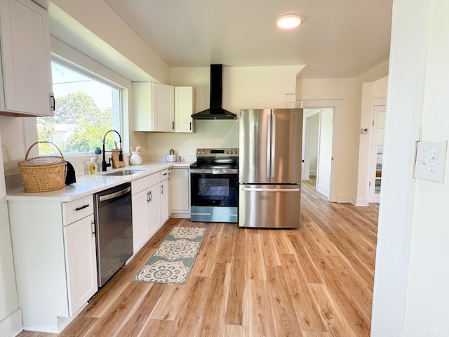 110 3rd St, Madison Heights, VA 24572 - kitchen with stainless steel appliances, wall chimney exhaust hood, light wood finished floors, and white cabinets