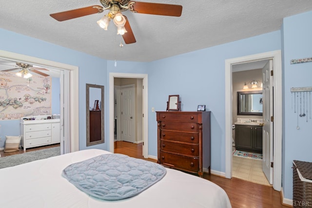 701 Goose Ridge Dr, Forest, VA 24551 - bedroom with dark wood finished floors, a textured ceiling, ceiling fan, and ensuite bath
