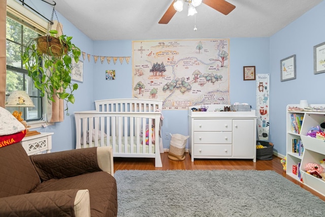 701 Goose Ridge Dr, Forest, VA 24551 - bedroom with a crib, wood finished floors, and a ceiling fan