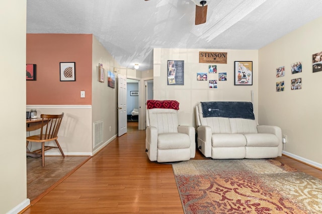 701 Goose Ridge Dr, Forest, VA 24551 - living area with wood finished floors, ceiling fan, and a textured ceiling