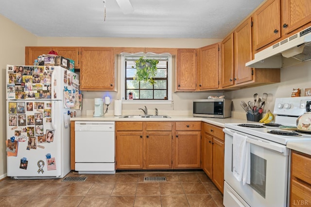 701 Goose Ridge Dr, Forest, VA 24551 - kitchen featuring white appliances, under cabinet range hood, light countertops, and brown cabinets