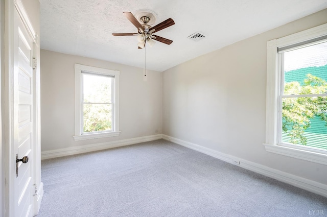838 Rivermont Ave, Lynchburg, VA 24504 - unfurnished room featuring a ceiling fan, carpet floors, and plenty of natural light