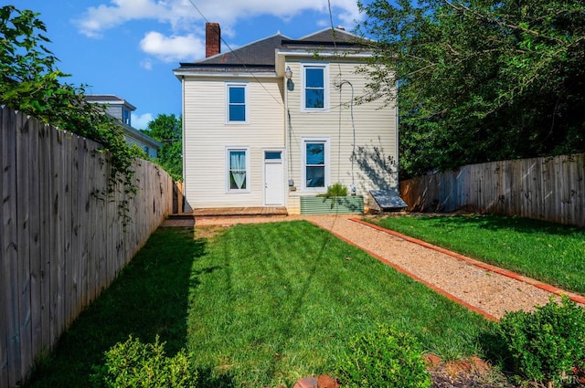 838 Rivermont Ave, Lynchburg, VA 24504 - back of property featuring a chimney and a fenced backyard