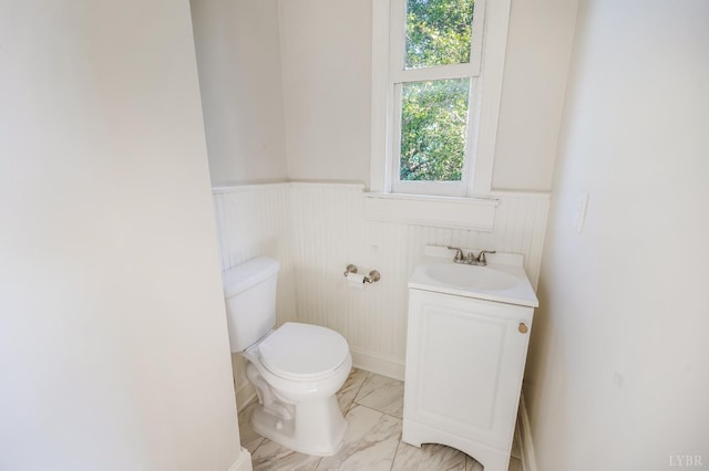 838 Rivermont Ave, Lynchburg, VA 24504 - half bathroom with wainscoting, marble finish floors, and vanity
