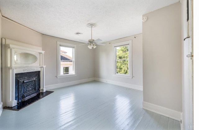 838 Rivermont Ave, Lynchburg, VA 24504 - unfurnished living room featuring wood finished floors, a textured ceiling, a fireplace, and ceiling fan